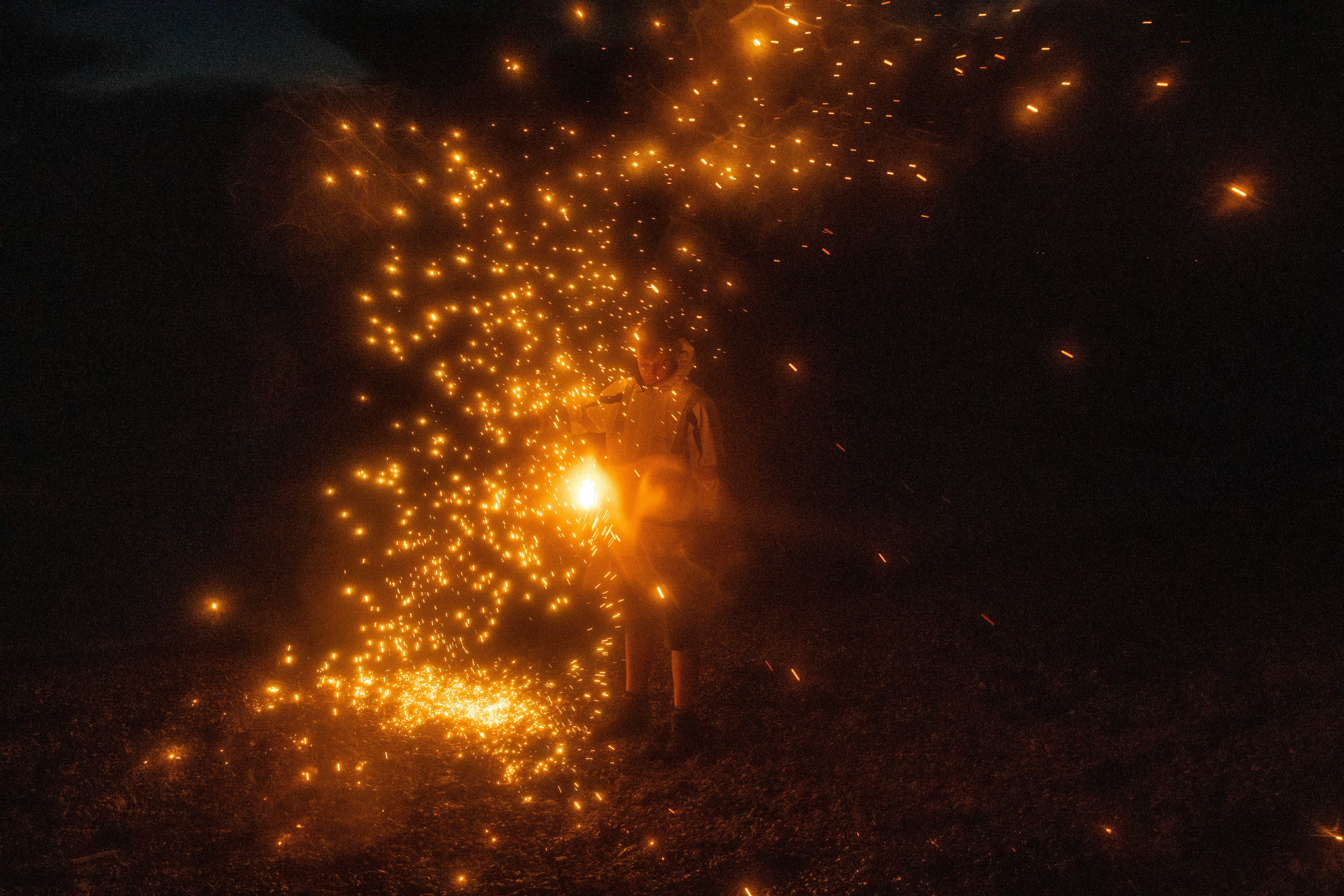 yellow fireworks on brown field during night time